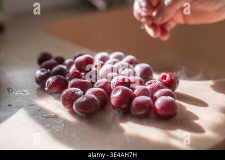 Autentic photo Frozen strawberries covered in frost lie on the table in the sunlight. Cold freez berries produce beautiful steam at room temperature. copy space or template background banner . High quality photo Stock Photo