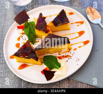 Custard tart on white plate, french cuisine Stock Photo