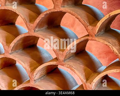 Terra cotta roof tlles are stacked to form a window screen in a house near Tecate. Stock Photo