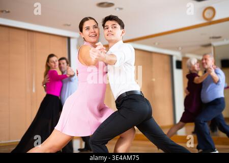 Young pair practicing ballroom dance in dance studio Stock Photo