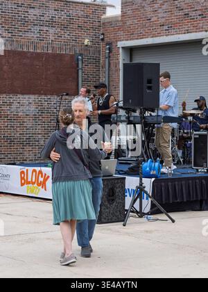 Panama City, FL, USA. 26th Mar 2026. Attendees dance to live music during the Bay County Chamber of Commerce's Annual Block Party. The lively celebration brings together Chamber members, community leaders, and local businesses for an evening of connection and fun. A major highlight of the night included the legendary T-Rex Races, which were held for the final time this year. This signature community event, with Chevron as the presenting sponsor, is a way to give back and celebrate all that makes Bay County special with great food, music, and an unbeatable vibe. Credit: Tosh Persons / 17�Թ�����... Stock Photo