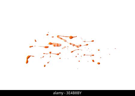 Random orange paint splatters and liquid droplets isolated on white background Stock Photo
