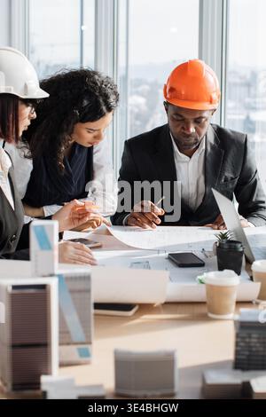 Architects Discussing Blueprints Stock Photo
