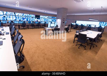 Modern surveillance control room with multiple monitors displaying security camera feeds. Concept of monitoring, safety, technology, and security oper Stock Photo