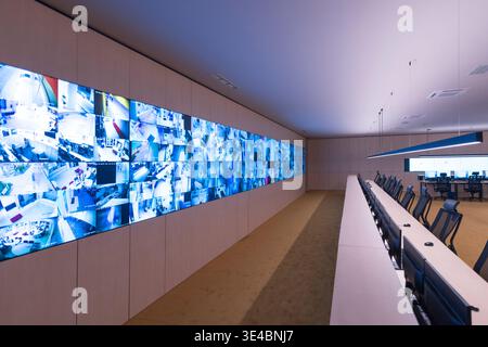 Modern surveillance control room with multiple monitors displaying security camera feeds. Concept of monitoring, safety, technology, and security oper Stock Photo