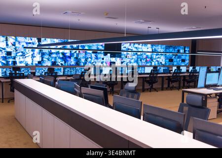 Modern surveillance control room with multiple monitors displaying security camera feeds. Concept of monitoring, safety, technology, and security oper Stock Photo