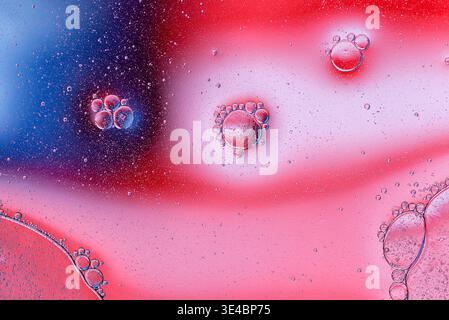 Soft pink fluid texture with transparent oil bubbles creating a gentle and artistic macro composition. Stock Photo