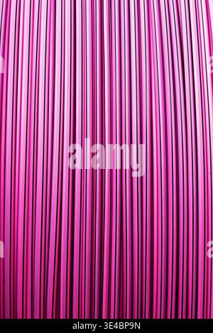 Vibrant magenta colored metal wall with vertical lines and industrial pattern for bright background design. Stock Photo