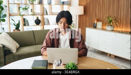 Serious, online and man with laptop in office, review and content creation with software on website. Editor, video editing and person with tech for Stock Photo