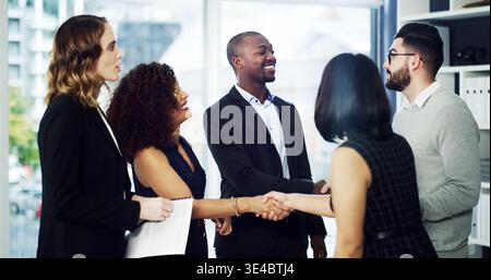 Corporate, lawyers and business people with handshake in office for agreement, merger and partnership. Happy, team and workers shaking hands with Stock Photo