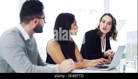 Laptop, discussion and business people in office for finance review, investment proposal and feedback. Corporate, team and workers on computer for Stock Photo