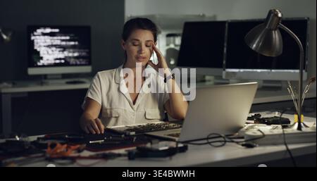 Stress, woman and programming with laptop at night for coding error, data loss and software crash. Frustrated, person and troubleshooting pc with Stock Photo