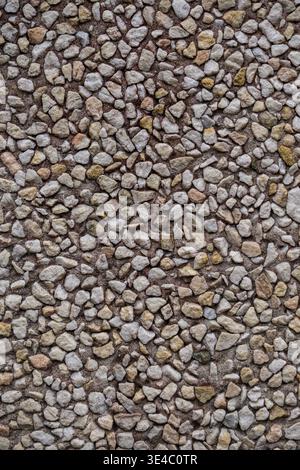 Close up of compact gravel surface with small stones of various shapes and colors. Stock Photo