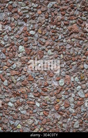 Close up of concrete surface filled with small multicolored stones creating a dense mosaic pattern. Stock Photo