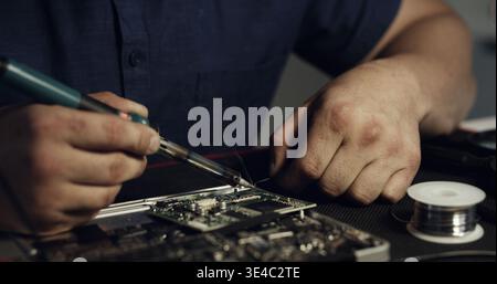Electronics Maintenance Engineer Soldering Motherboard, Microchip and ...