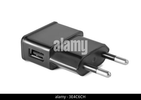 Black USB plug charging adapter lying on white background Stock Photo