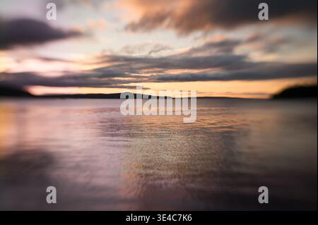 Vibrant pink, purple, peach sunset over Atlantic Ocean in Maine Stock Photo