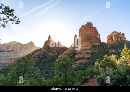 Starburst sun setting behind rock formations landscape Stock Photo