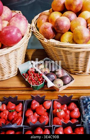 Assorted fresh fruits in market baskets and punnets Stock Photo