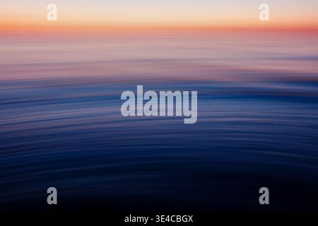 Abstract blue ocean motion blur with flowing wave patterns Stock Photo