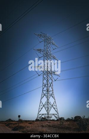 Power Lines for Electricity against a blue sky Stock Photo