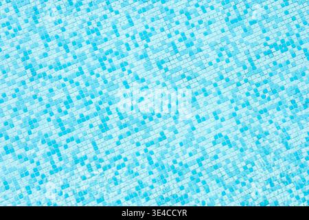 A textured background of light blue tiles arranged in a mosaic pattern. The design features various shades of blue, creating a calming visual effect. Stock Photo