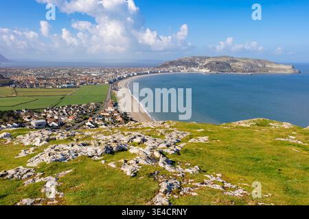 Rocky headland of The Great Orme and north shore beach seen across Llandudno Bay from The Little Orme on Welsh coast.  Llandudno Conwy North Wales UK Stock Photo
