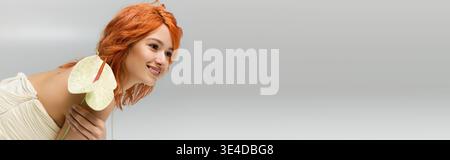 Red haired beauty in a strapless dress showcases spring style and confidence with charm, banner Stock Photo
