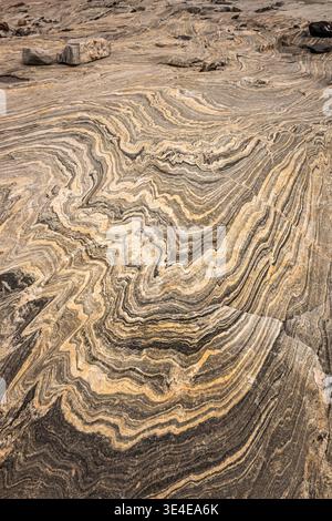 When this granite rock was relieved of its weight by the melting ice shield, it 'bounced' back up. amazing patterns, even formed letters are revealed. Stock Photo