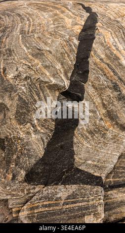 When this granite rock was relieved of its weight by the melting ice shield, it 'bounced' back up. amazing patterns, even formed letters are revealed. Stock Photo