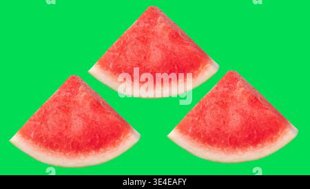 Front view set of fresh ripe red watermelon fruit in three slices or pieces is isolated on green background with clipping path. Stock Photo