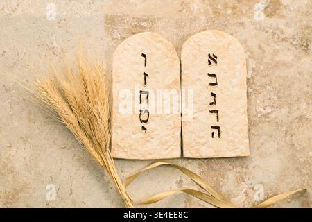 Ten commandments stone tablets with wheat for shavuot Stock Photo