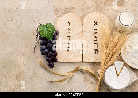 Shavuot ten commandments with traditional dairy and grain foods Stock Photo