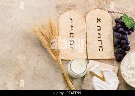 Shavuot holiday symbols with tablets and dairy Stock Photo