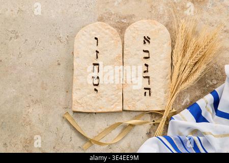 Ten commandments tablets with wheat and tallit celebrating shavuot Stock Photo