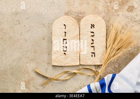 Shavuot holiday with ten commandments tablets, wheat and tallit Stock Photo
