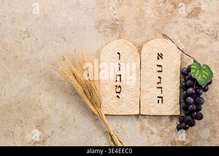 Ten commandments tablets with wheat and grapes for shavuot Stock Photo
