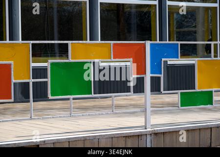 Brightly colored fence panels create a cheerful atmosphere for outdoor activities. Stock Photo