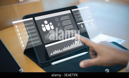 Human resource management system on digital tablet screen.Smart recruitment and hiring technology for modern business.Employee performance data analyt Stock Photo