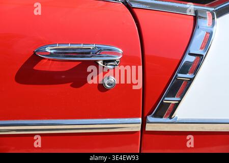 Chrome, Bodywork and Door Handle Detail of Two-Door or 2 Door Red and White Chevrolet Bel Air 2 Vintage Car or Automobile from early 1950s. Stock Photo