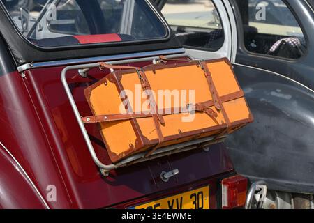 Vintage Leather Luggage or Suitcase Strapped to Rear Luggage Rack or Luggage Carrier of Vintage Citroën 2CV Motor Car Stock Photo