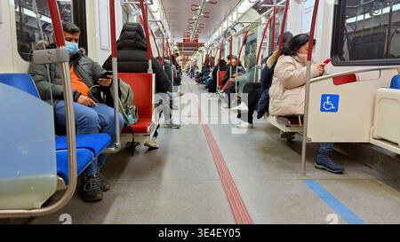 Toronto, ON, Canada - March 26, 2026: Interior of the subway train with passengers seated, some of them are wearing protective face masks. Stock Photo