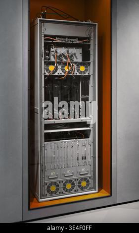 Industrial server rack and power distribution unit. A high-tech server rack with cooling fans, power modules, complex wiring - network infrastructure. Stock Photo