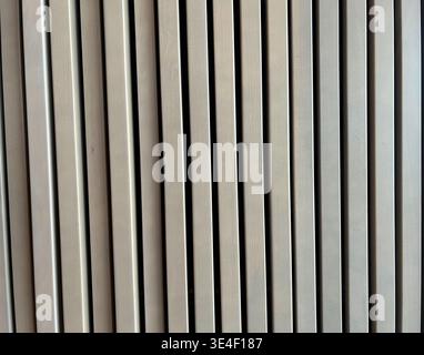 abstract wooden background featuring vertical lines and subtle texture in neutral tones. clean minimal design with repeating pattern and modern panel. Stock Photo