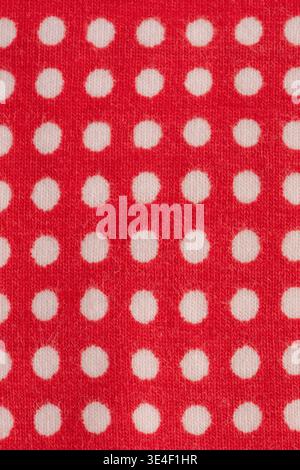 Red fabric with white polka dots macro photo as background Stock Photo