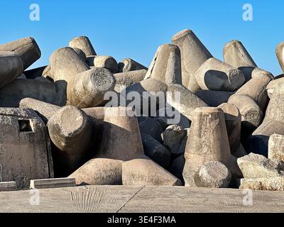 Concrete blocks piled up at the edge of the sea become a breakwater for the port of Rethymno on the island of Crete in Greece. Stock Photo