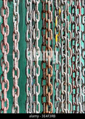 Rusty chains at an old boat yard on San Juan Island create a background image with an industrial pattern. Stock Photo