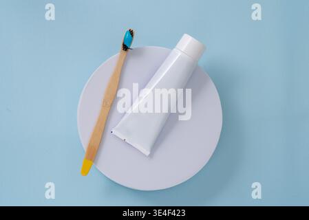 Cosmetic tube with brush on blue background. Stock Photo