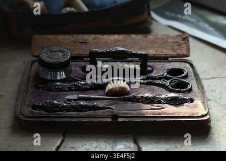 A vintage barber toolbox featuring traditional grooming tools and equipment used in historical barbering practices. Stock Photo