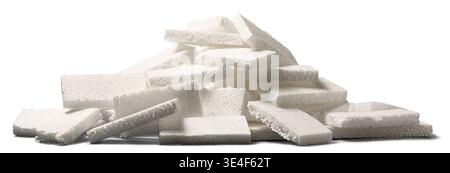 pile of white styrofoam pieces isolated white background, porous textured polystyrene material, side view environmental waste concept Stock Photo